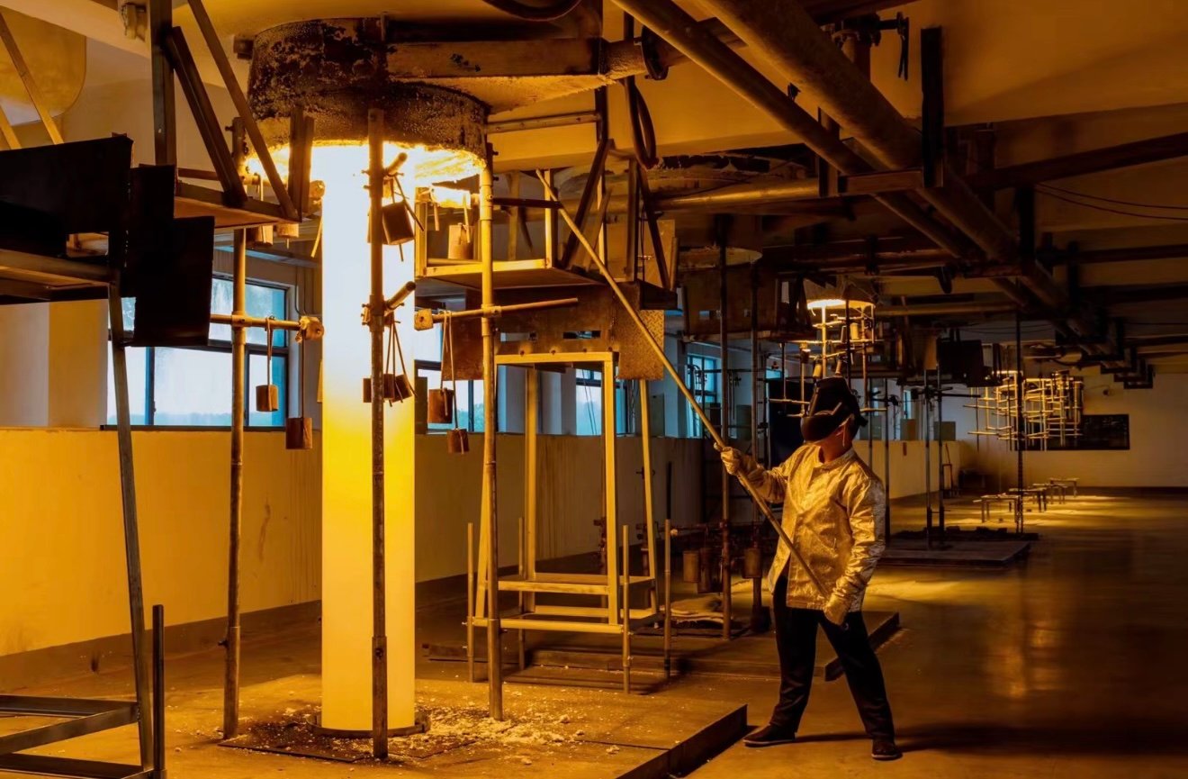 Worker processing quartz glass tube during manufacturing process